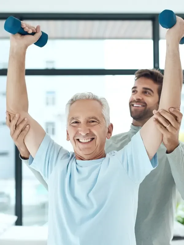 A patient exercising with a practitioner after treatment